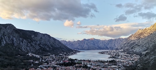 a scenic view of a city and a lake