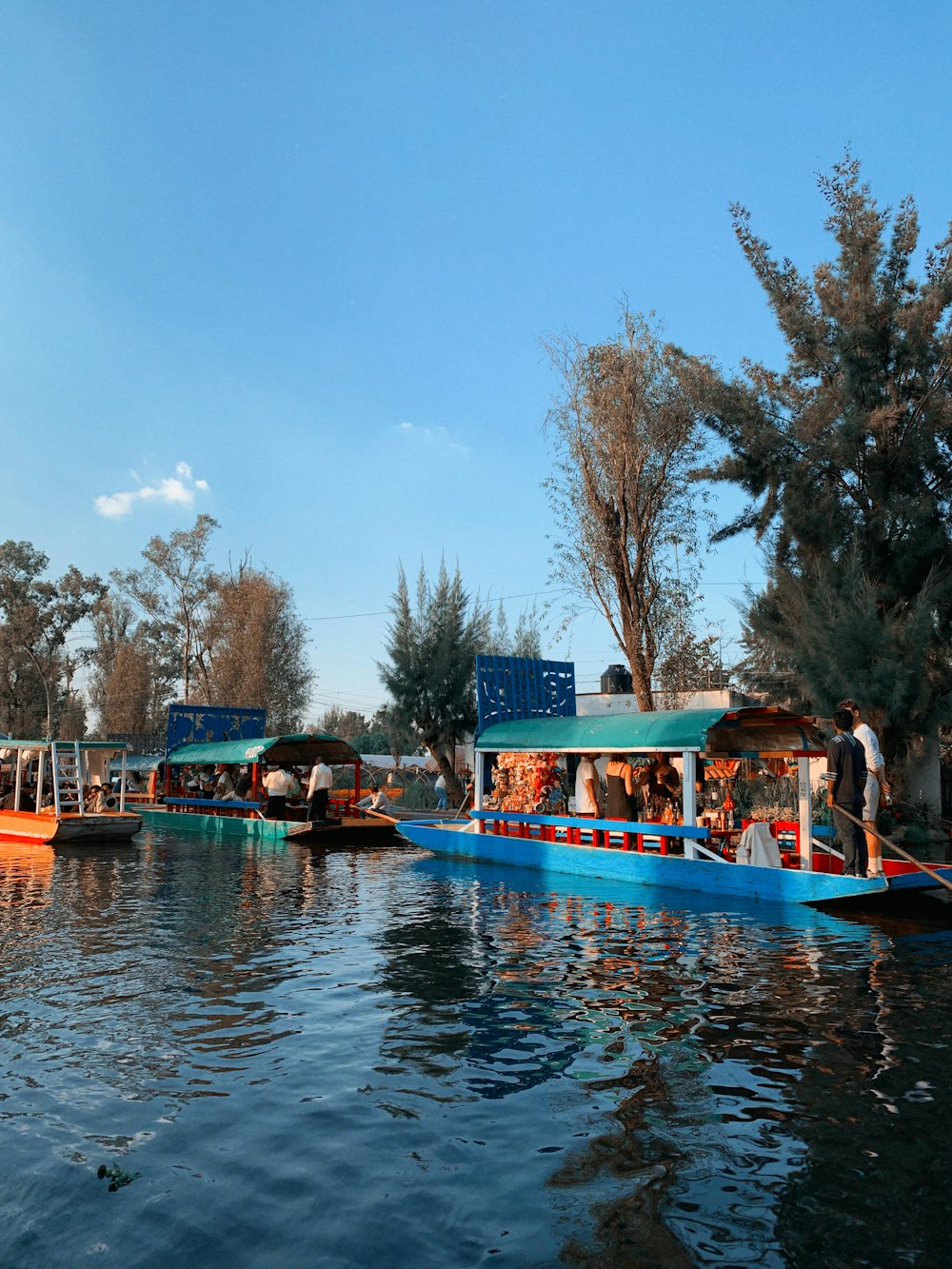 a group of boats floating on top of a lake