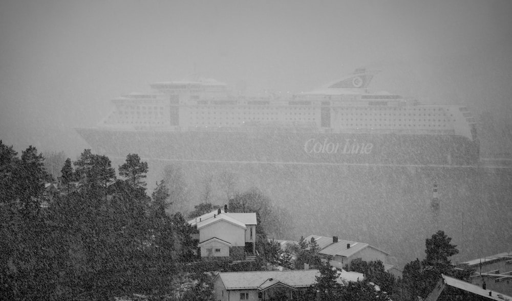 a black and white photo of a cruise ship in the rain