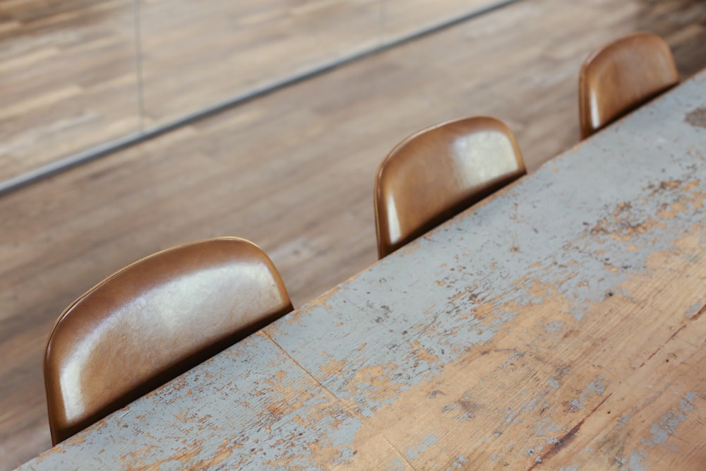 une table en bois avec quatre chaises à côté