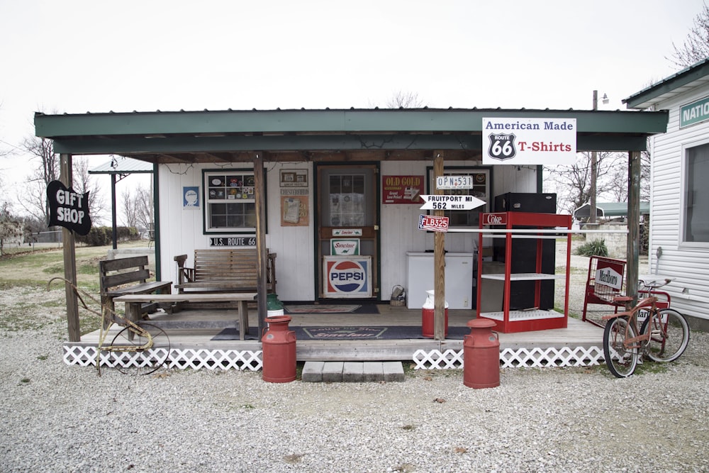 an old fashioned gas station with a bicycle parked outside