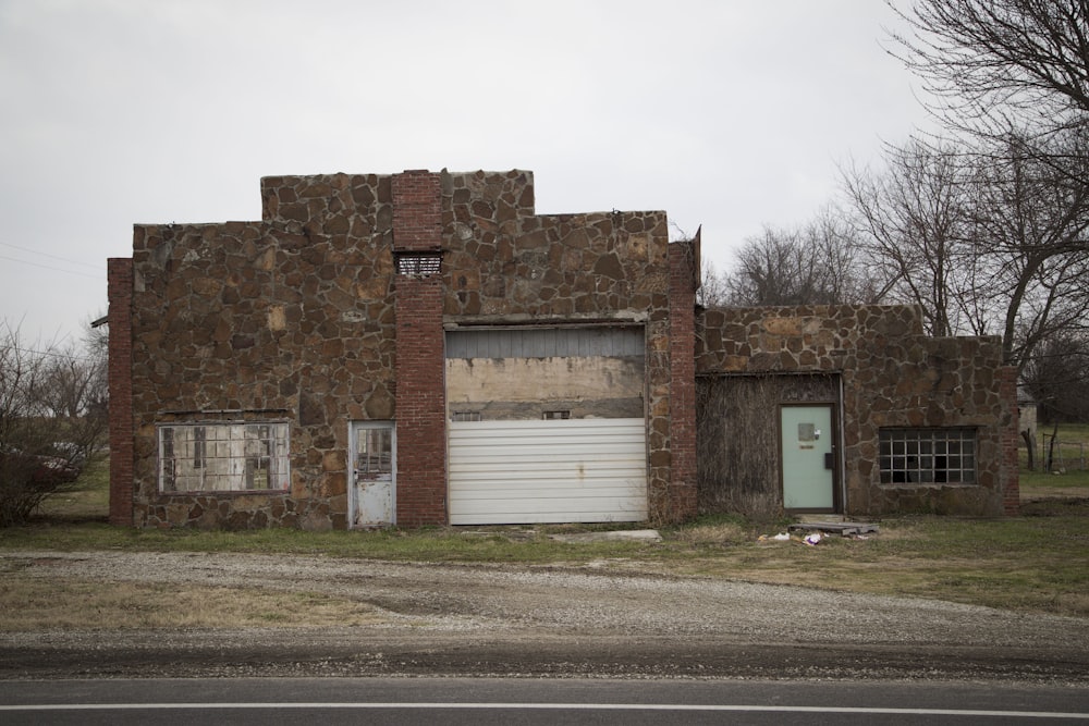 an old run down building with a garage