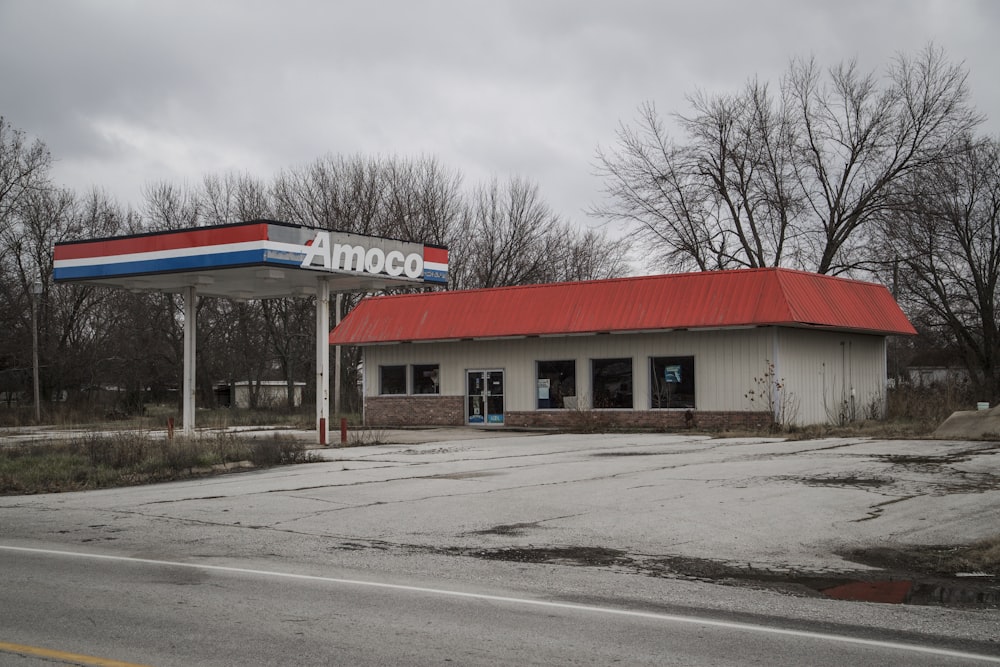 an empty gas station with a red roof