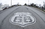 a route 66 sign painted on the side of a road