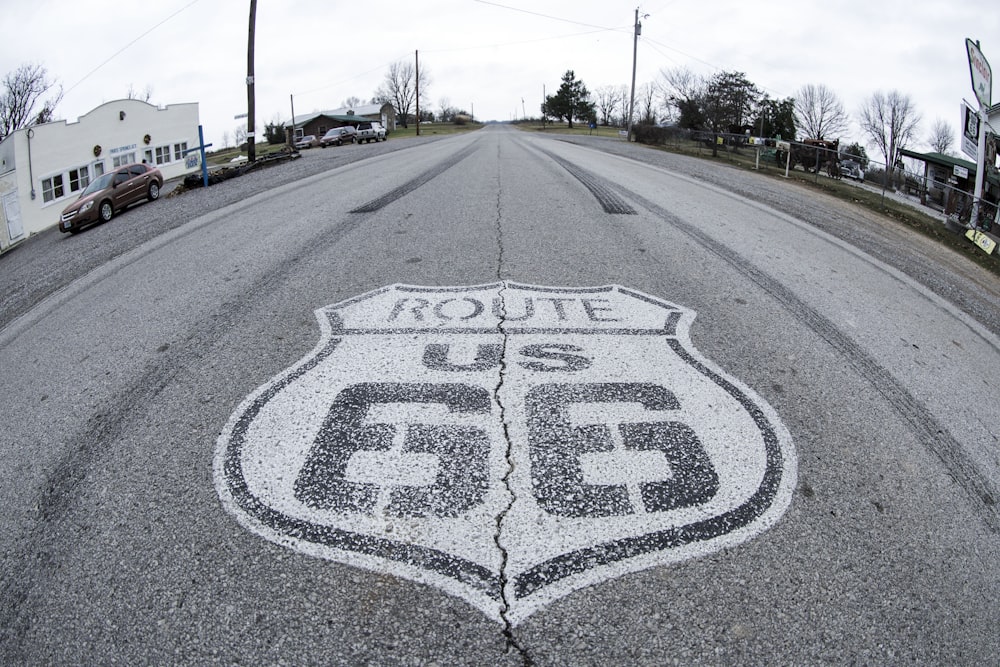 a route 66 sign painted on the side of a road