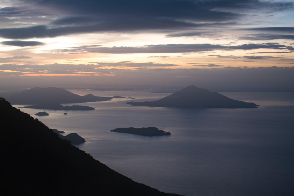 a view of a body of water with mountains in the background