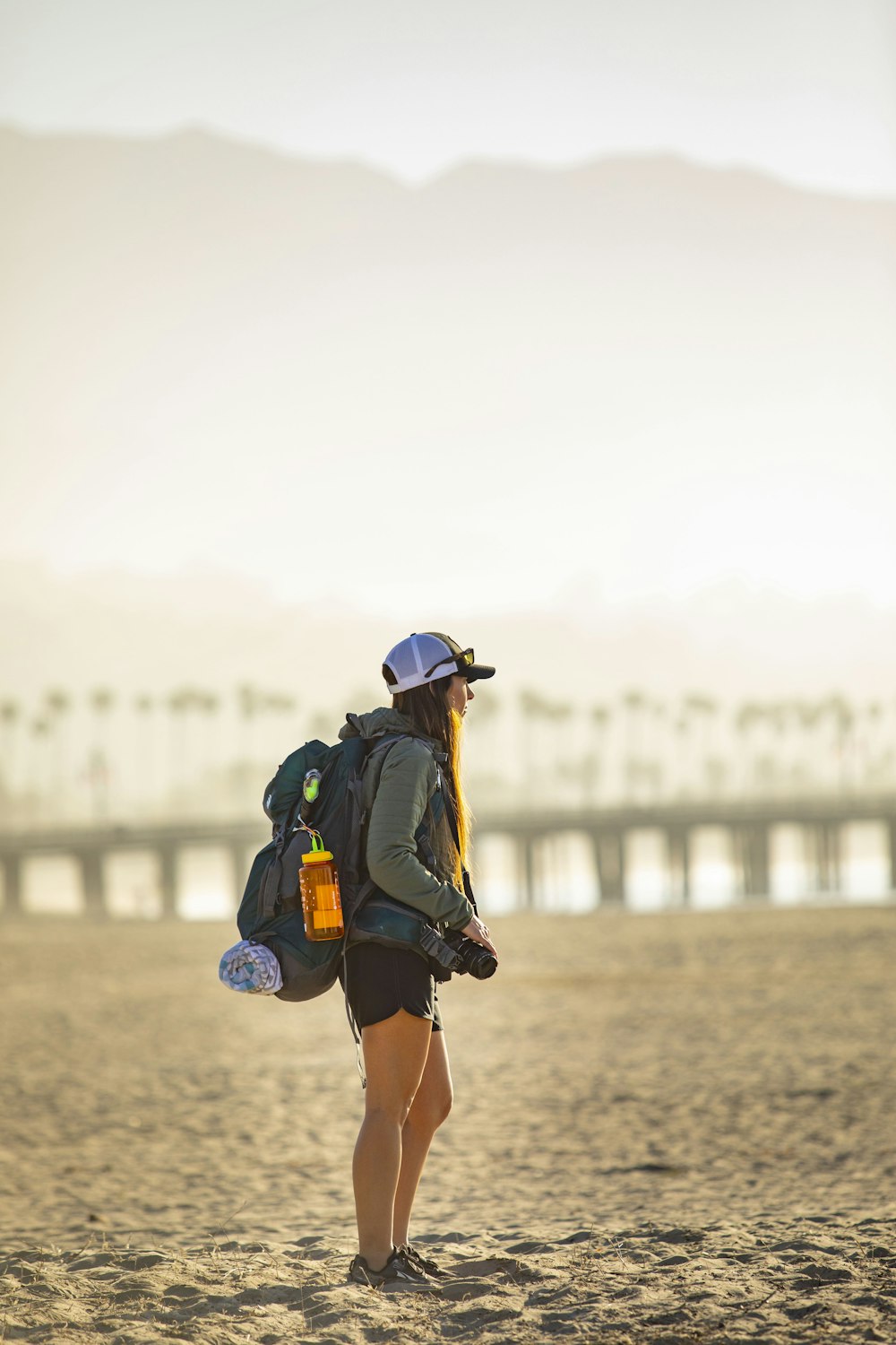 Une femme avec un chapeau et un sac à dos sur une plage photo – Photo Sac  Gratuite sur Unsplash