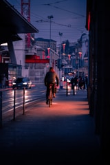 Bright LED bike lights glowing on an e-bike during a twilight ride through city streets.
