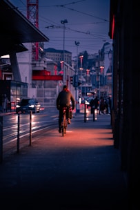 Bright LED bike lights glowing on an e-bike during a twilight ride through city streets.