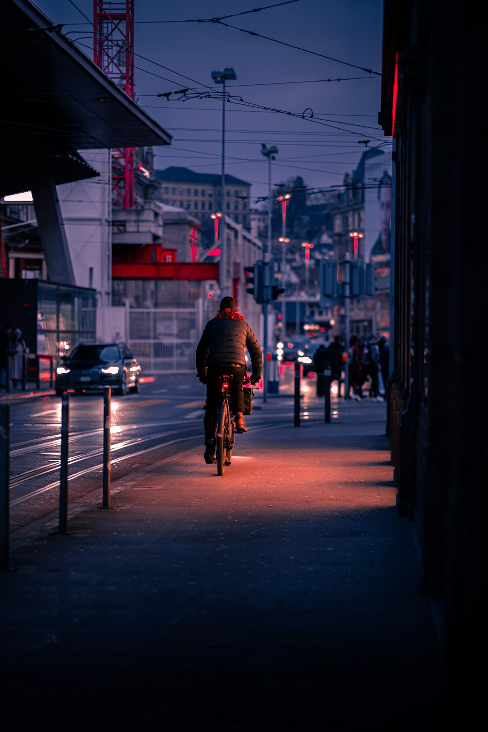 a man riding a bike down a street at night