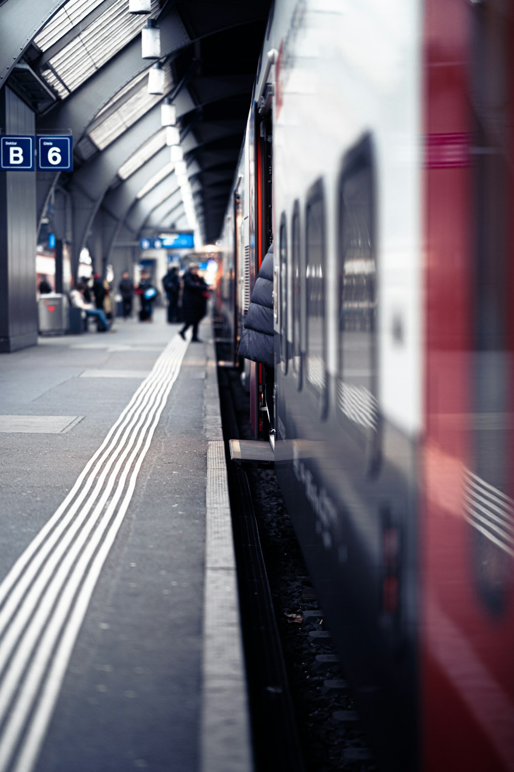 a train pulling into a train station next to a platform