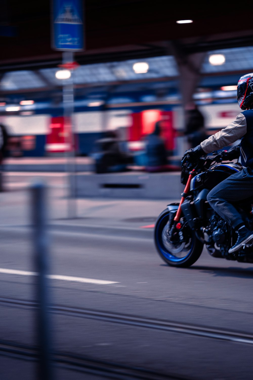 a man riding a motorcycle down a street