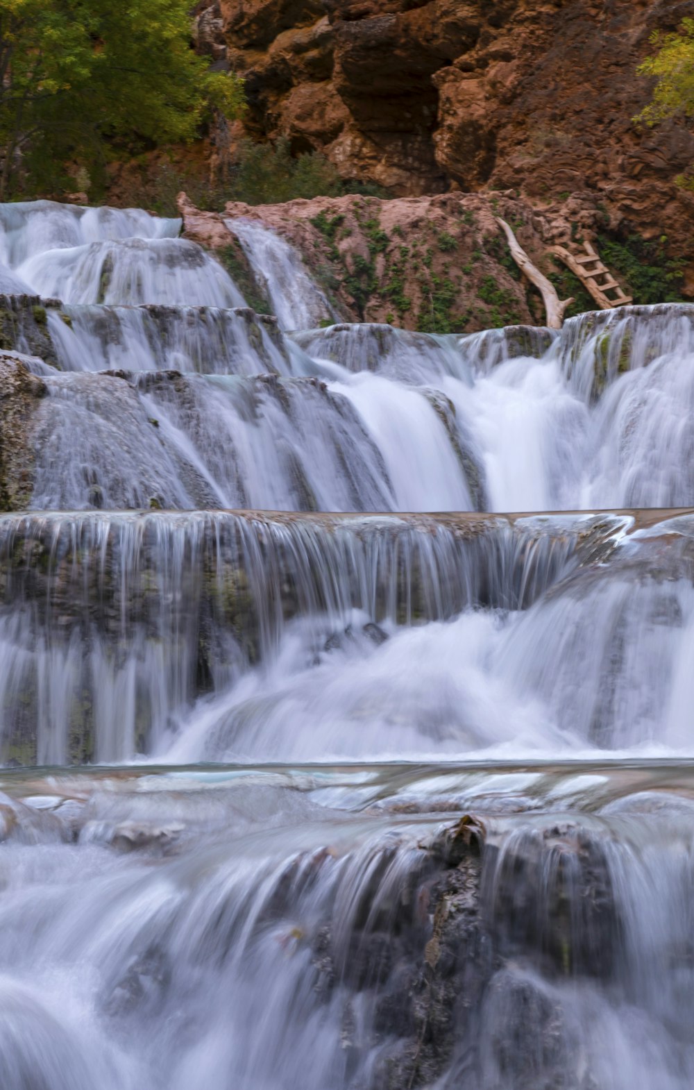 a man standing in the middle of a waterfall