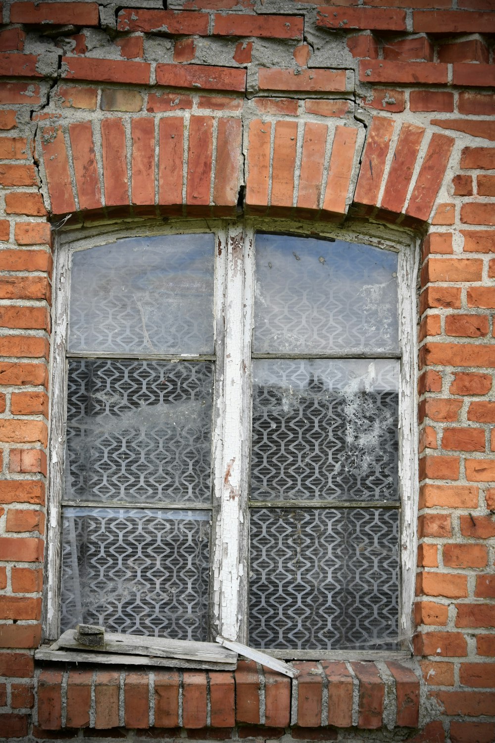 a brick building with a window and a window pane