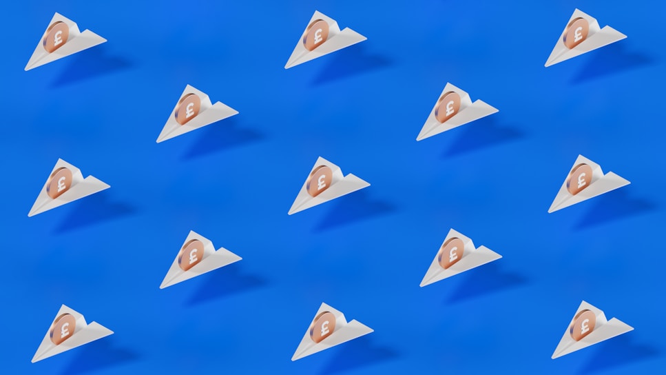 A pattern of small triangular packages, each with a coin featuring a pound symbol, is arranged uniformly across a bright blue background. The design is minimalistic and modern, featuring clean lines and a stark contrast between the blue and the white of the packages.