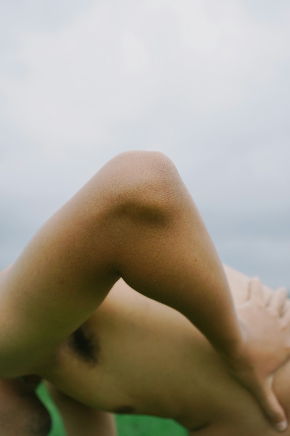 a woman laying on her back in a field