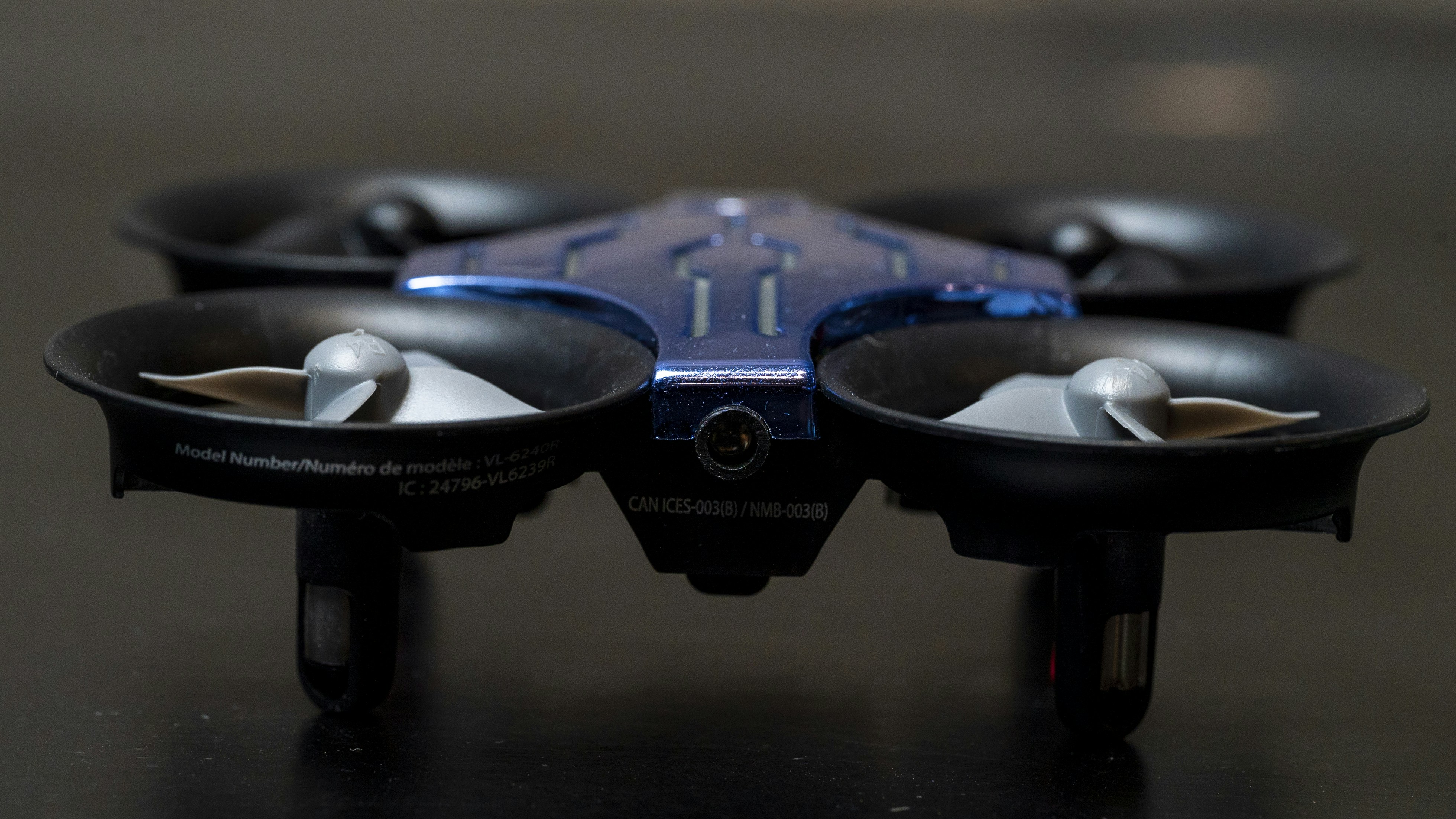 a close up of a blue and black flying device