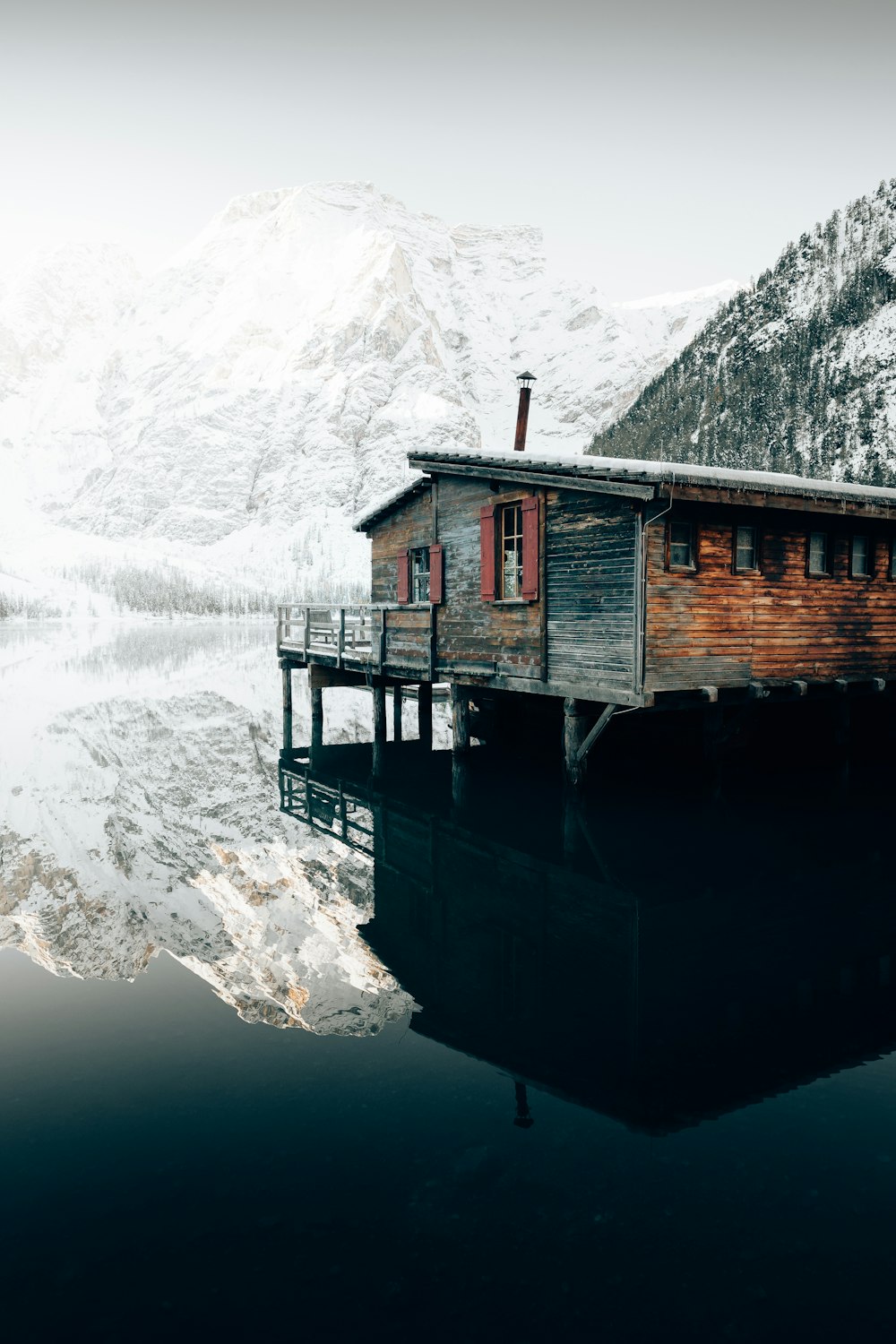a small wooden house sitting on top of a body of water