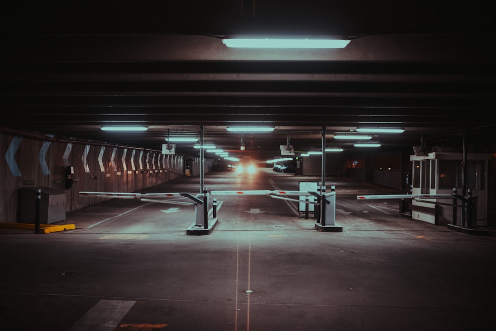 an empty parking garage with lights on the ceiling