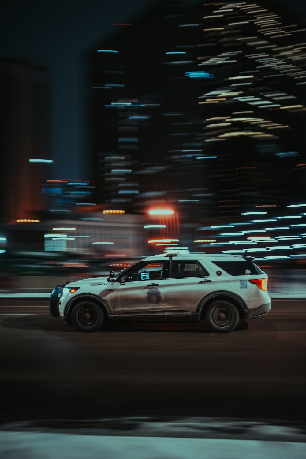 a police car driving down a city street at night