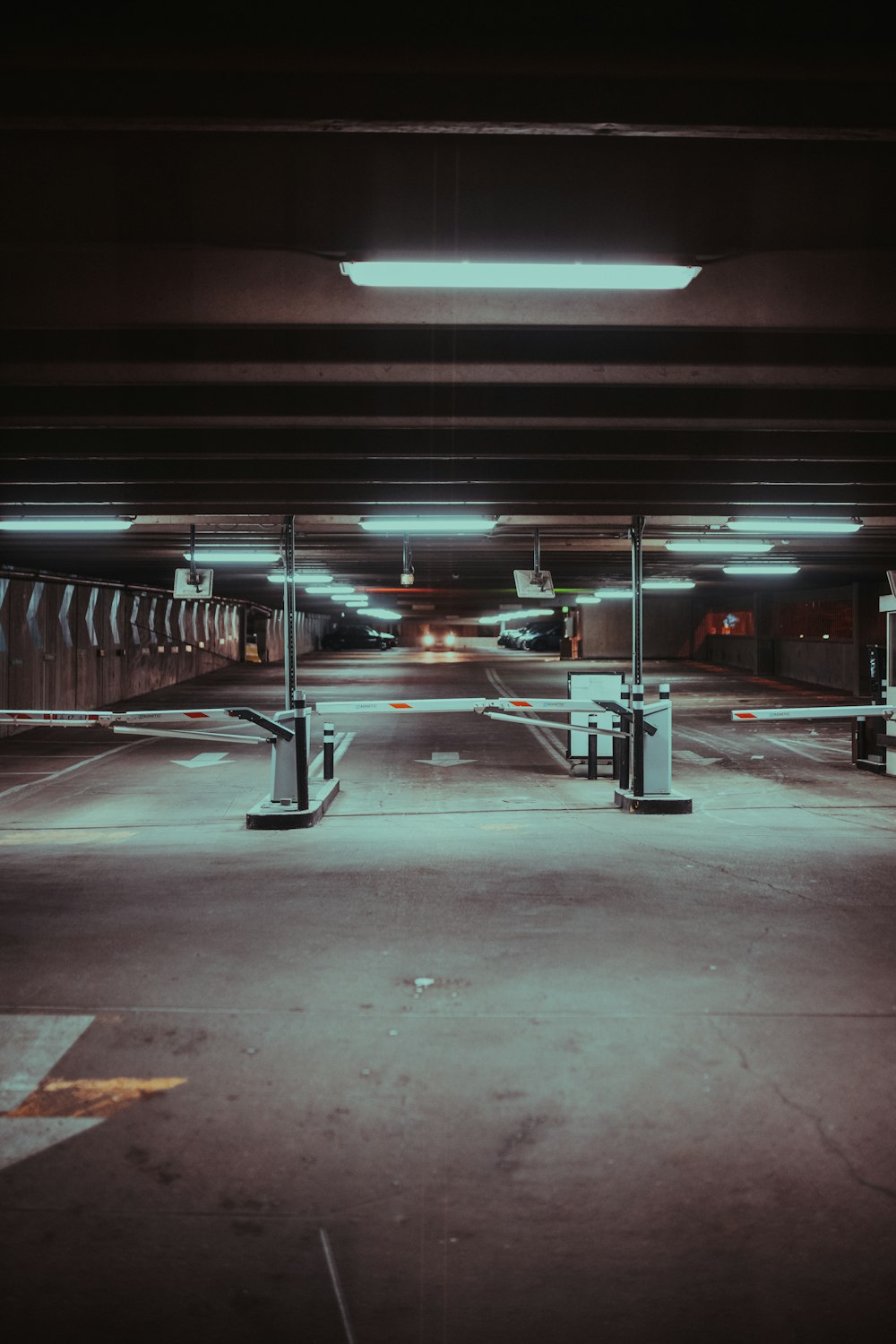 an empty parking garage with lights on the ceiling