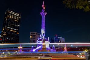 The iconic monument of Petrolina illuminated at night against a deep orange sky