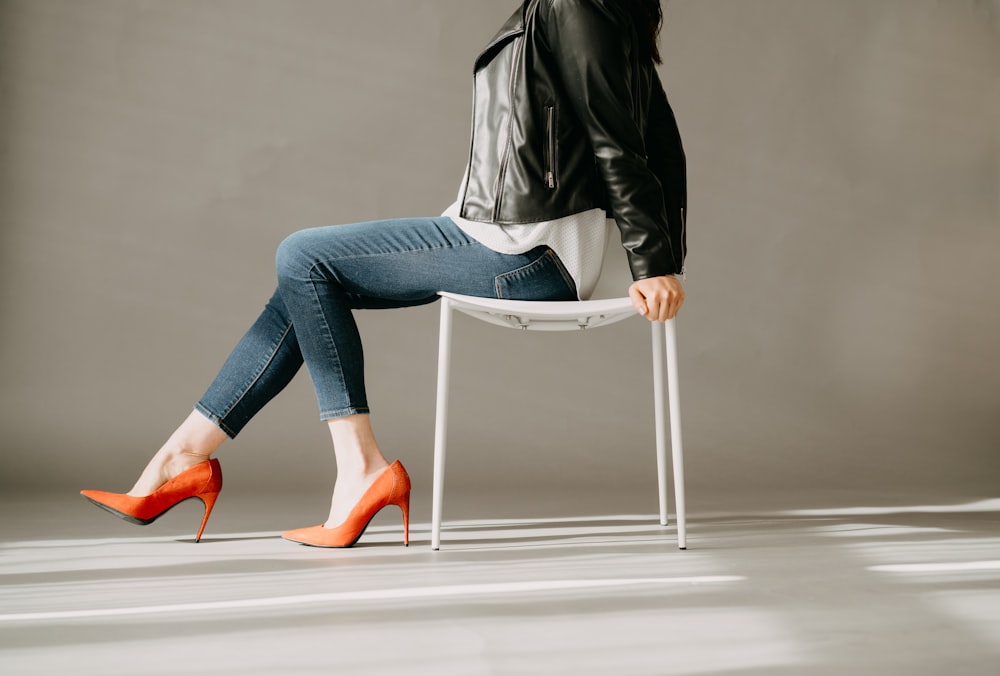 a woman sitting on a chair with her legs crossed