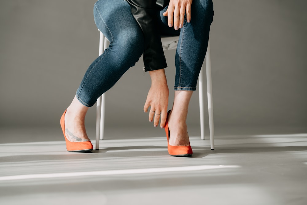 a woman sitting on a chair with her legs crossed