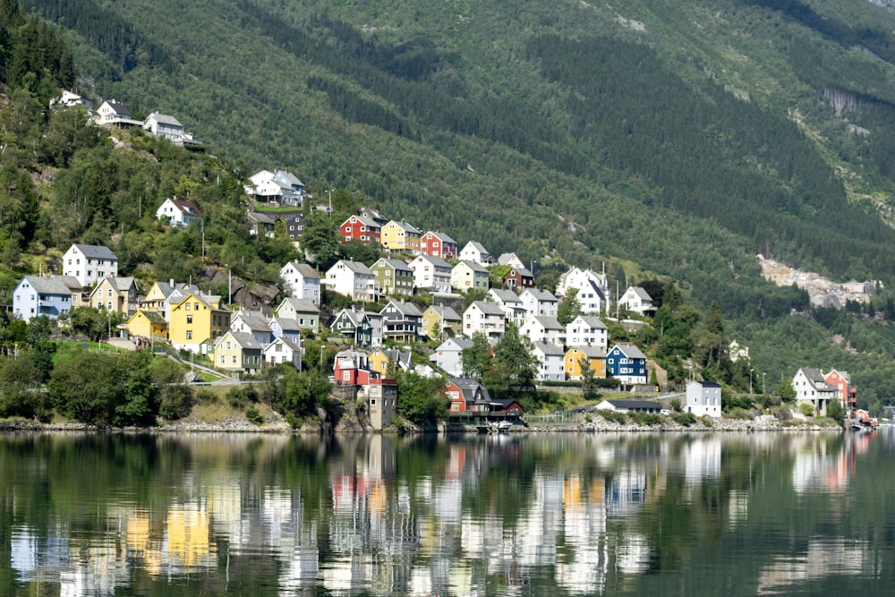 a small town on a hill with a lake in front of it