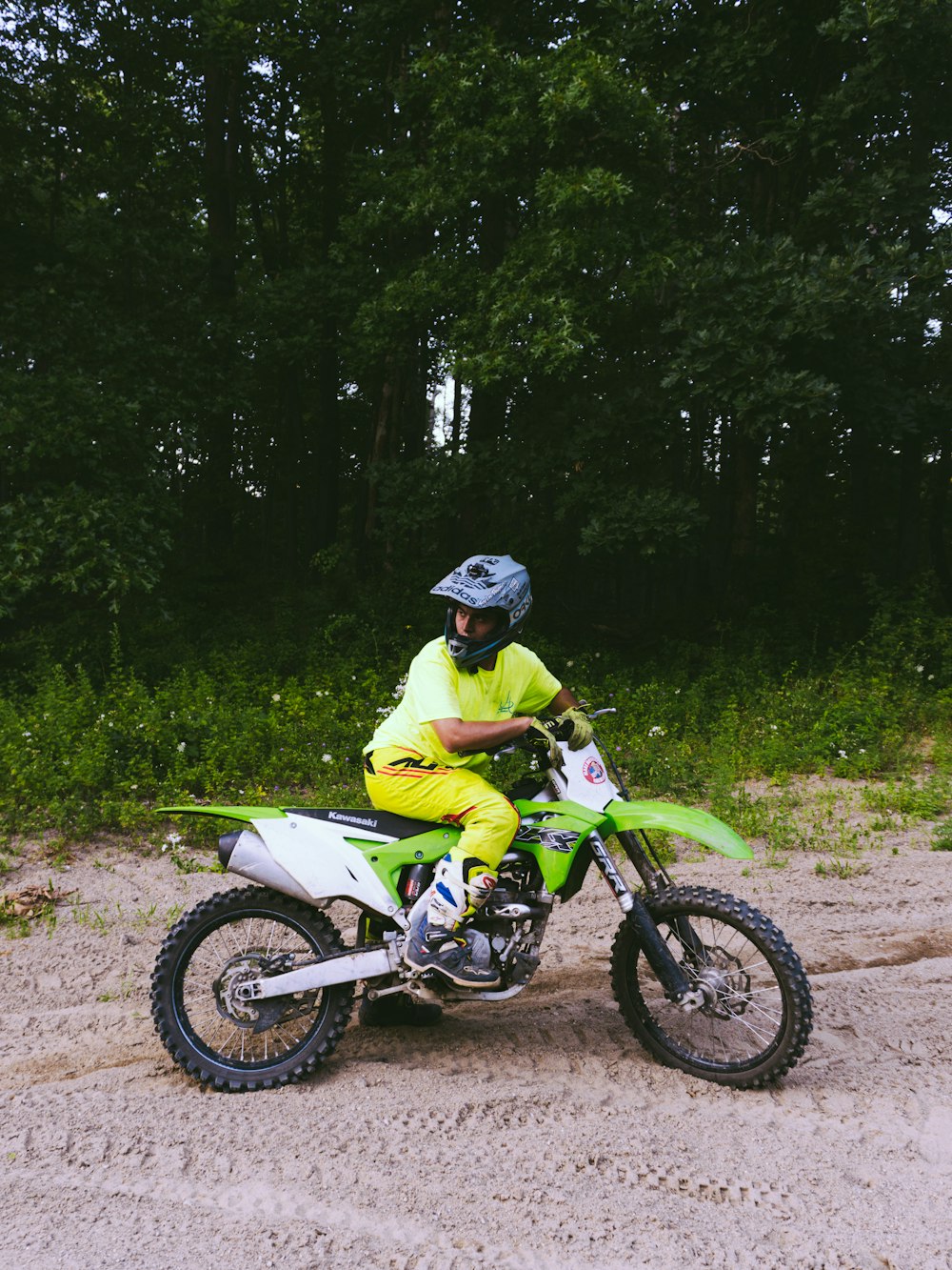 a man riding a dirt bike on top of a dirt field