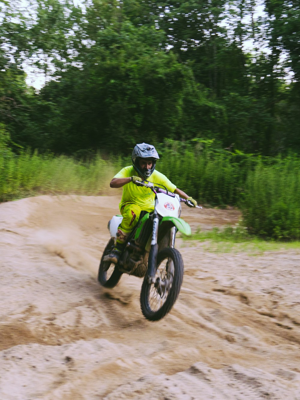 a person riding a dirt bike on a dirt road