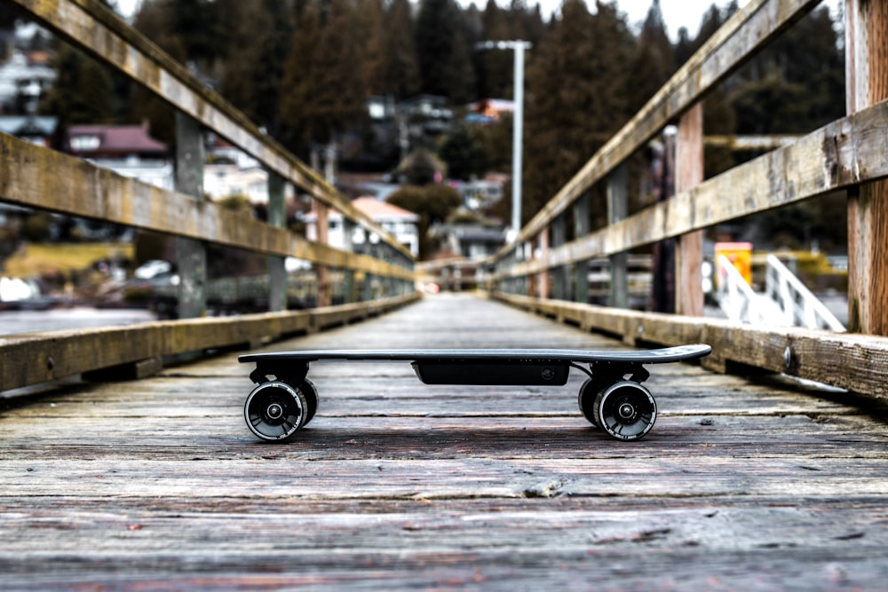 a skateboard is sitting on a wooden bridge