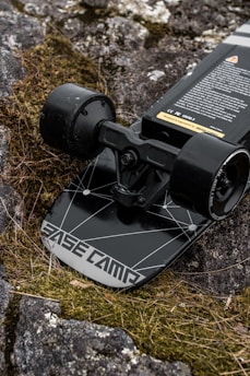 A close-up of a handcrafted eucalyptus wood skateboard deck with the Himalayandeck logo, resting on a sunlit street in India.