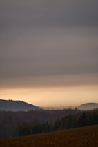 A calm Wyoming landscape at dusk with charcoal-colored mountains in the background.