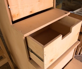 a wooden dresser with drawers and a mirror