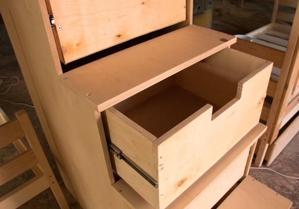 a wooden dresser with drawers and a mirror