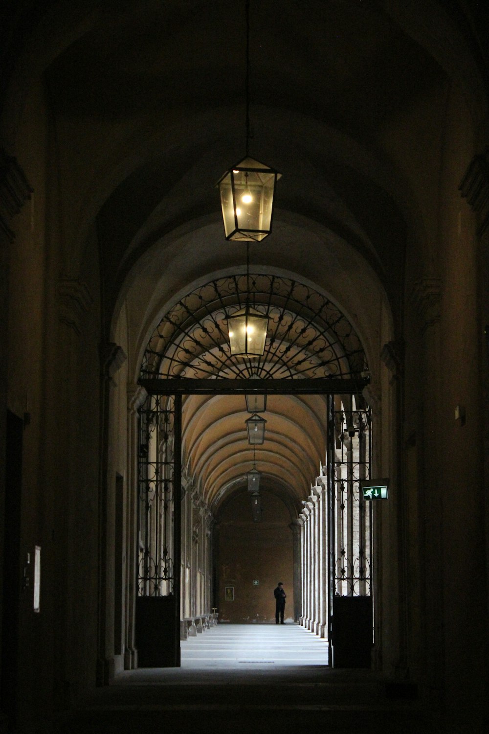 a person is walking down a hallway in a building