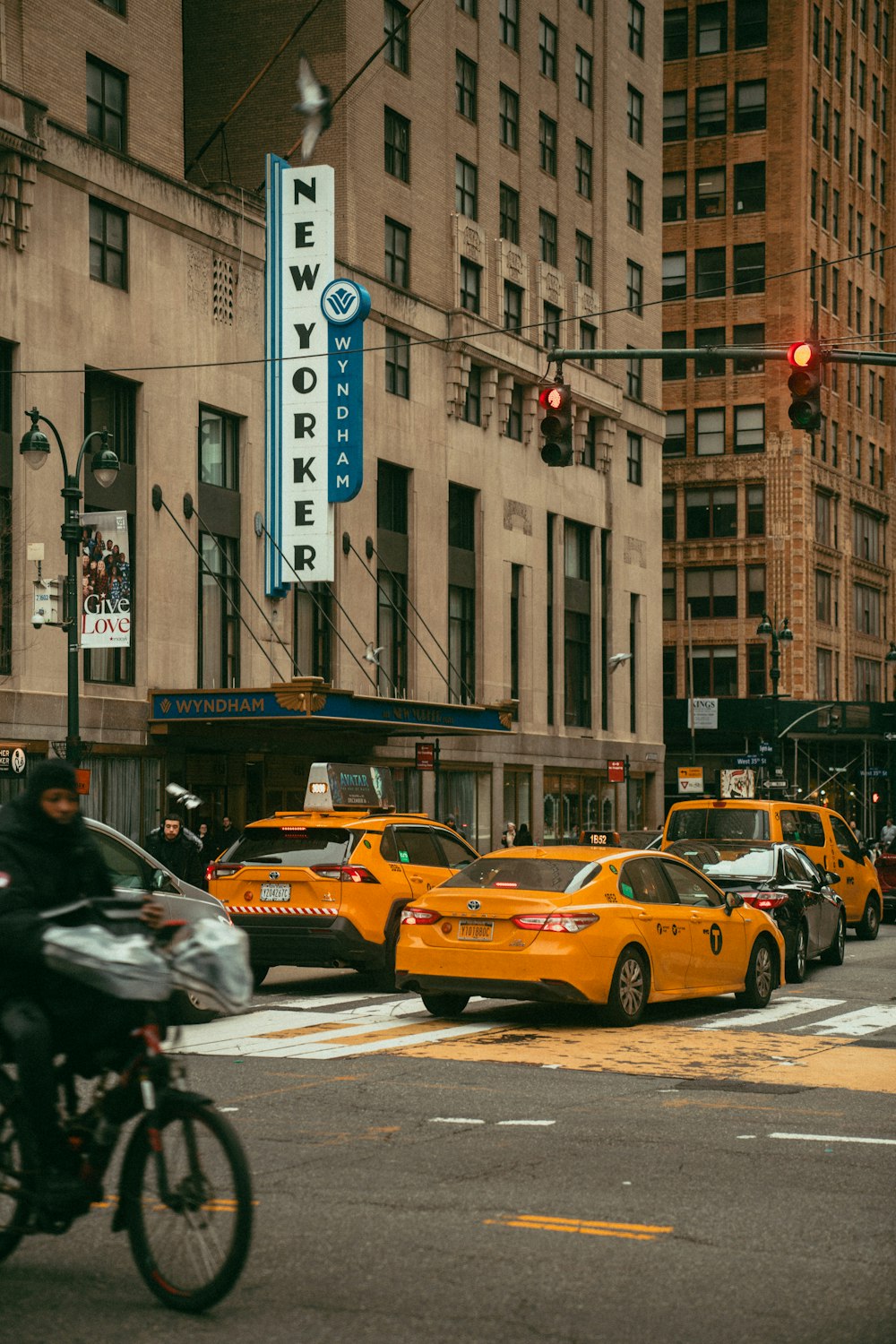 a city street filled with lots of traffic next to tall buildings