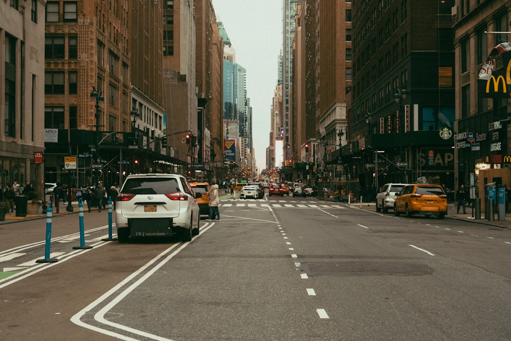 a city street filled with traffic and tall buildings