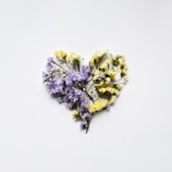 dried flowers arranged in the shape of a heart