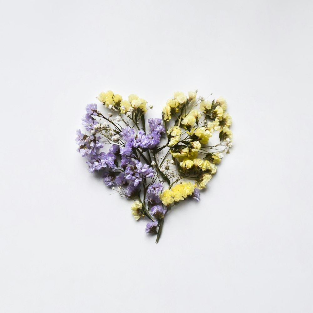 dried flowers arranged in the shape of a heart
