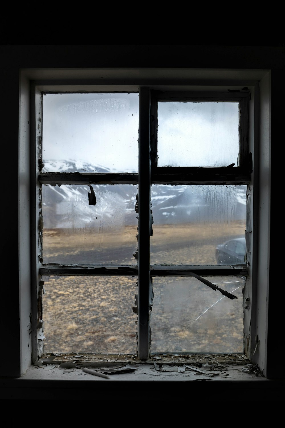 a window with a view of a snowy mountain