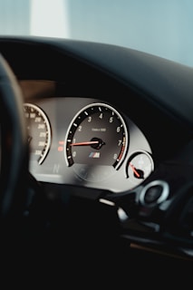 Close-up of a sleek car dashboard with high-performance gear accessories displayed.