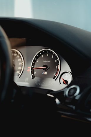 Close-up of a sleek car dashboard with high-performance gear accessories displayed.