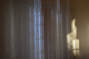 Soft pastel blue and off-white abstract shapes creating a feeling of calm balance.