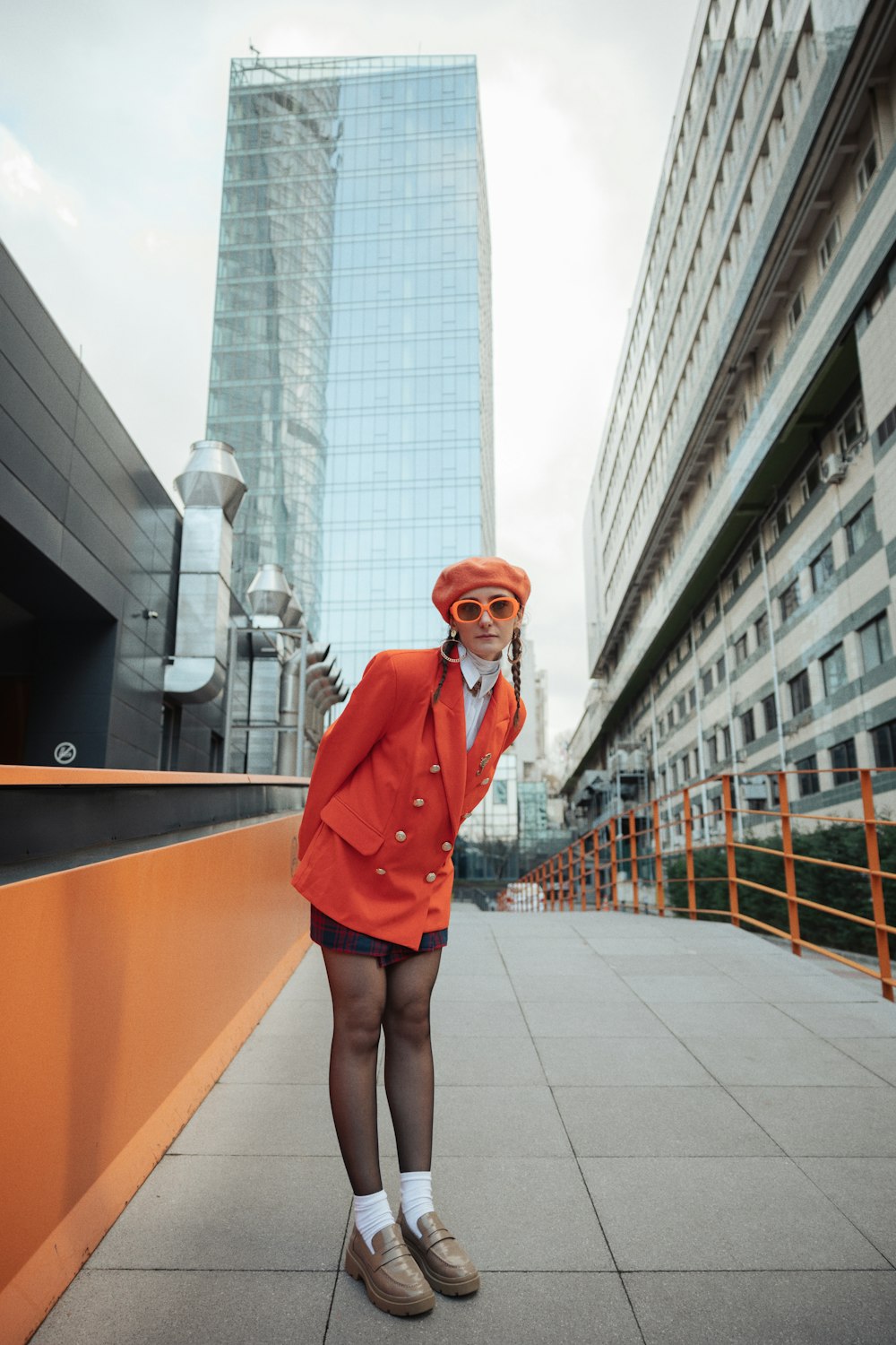 a woman in a red jacket and orange hat