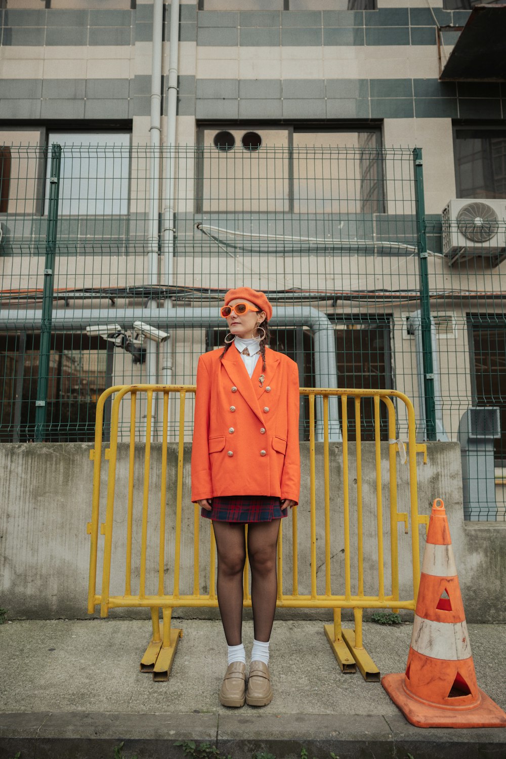 a woman standing in front of a yellow barricade