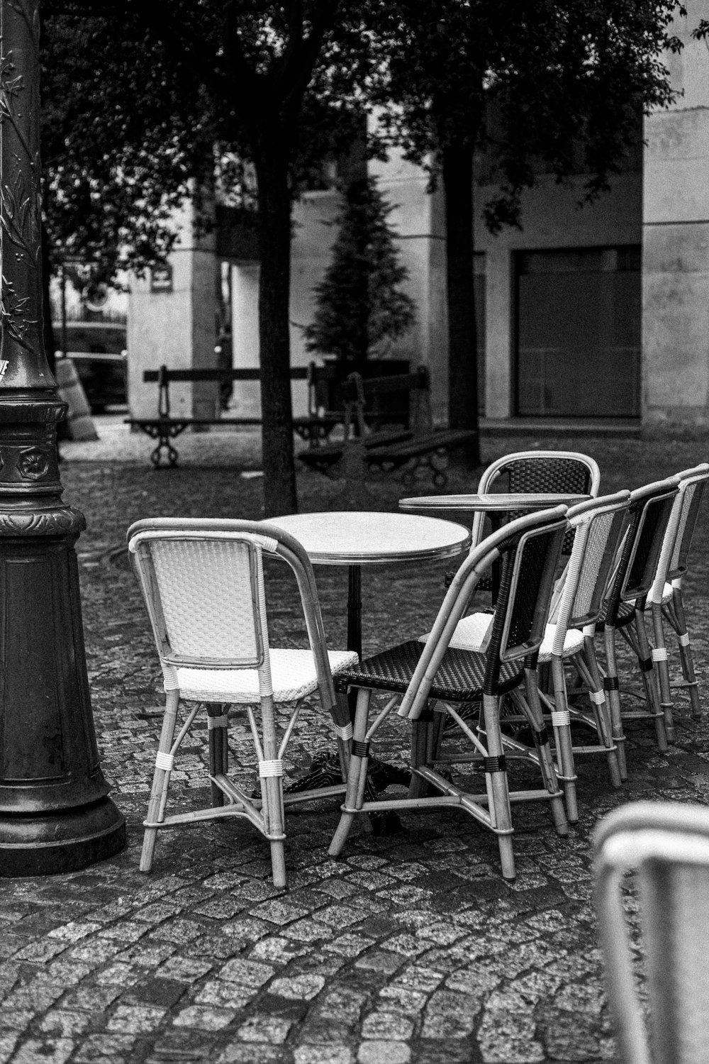 a black and white photo of a table and chairs