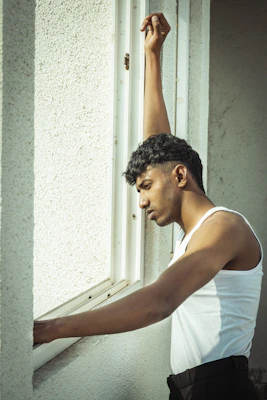 A casual yet chic tank top perfect for layering, photographed in a sunlit café setting.