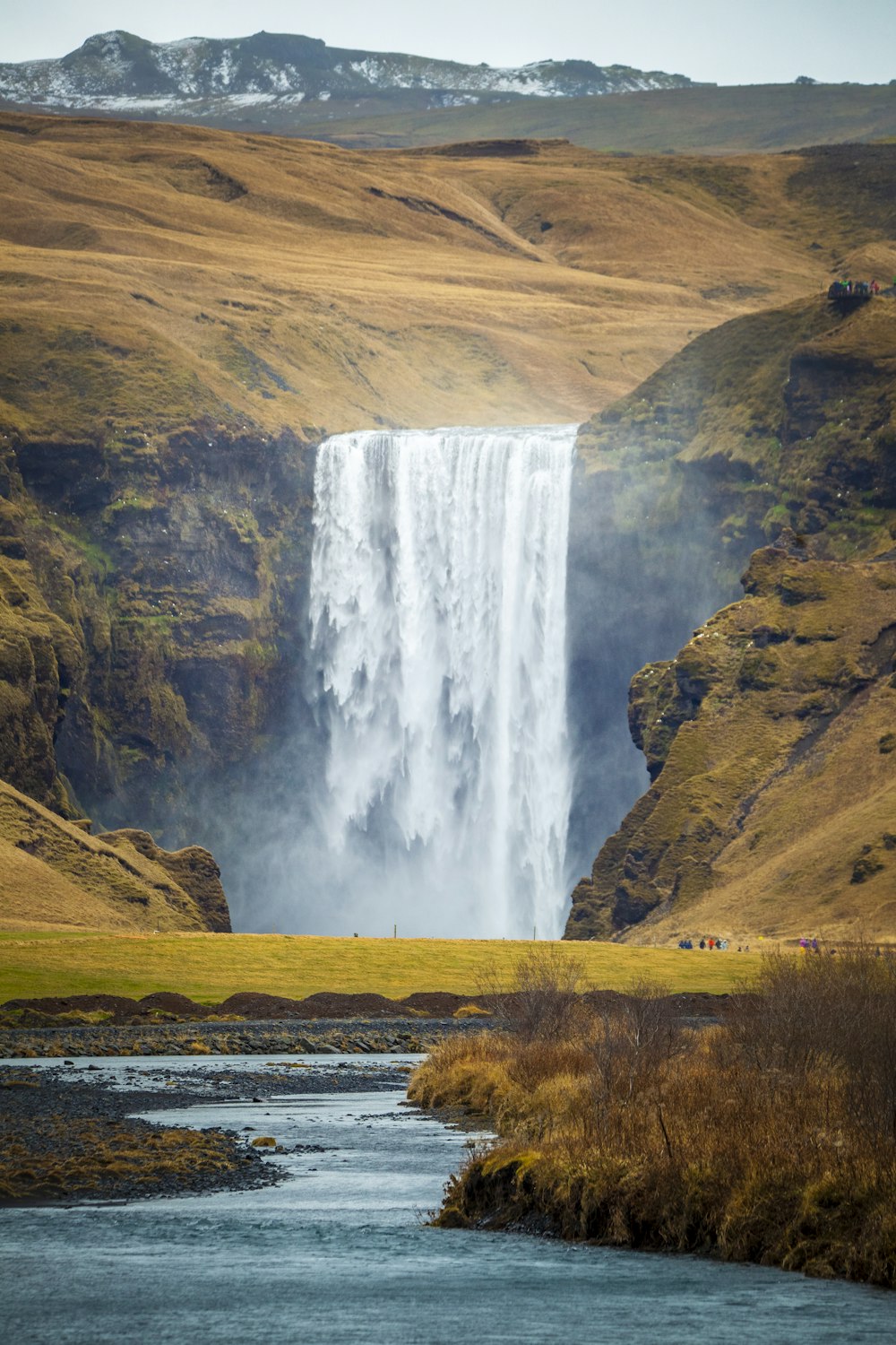 a large waterfall in the middle of a valley